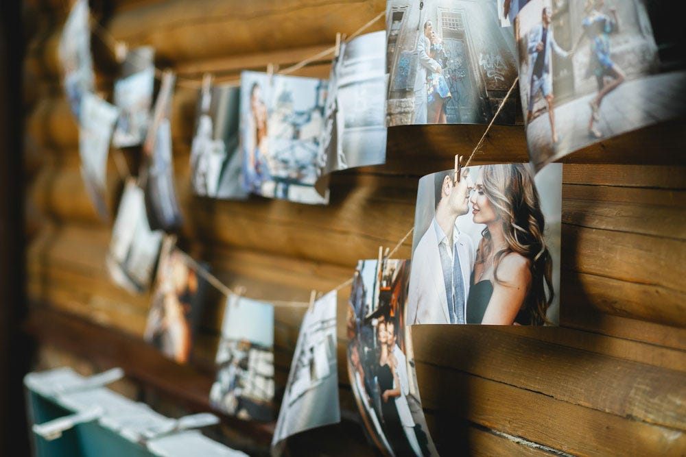 printed photos hanging on clothespins