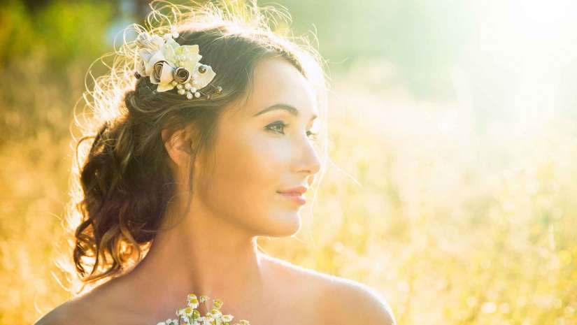 Portrait of a lady holding a bouquet of flowers outdoors