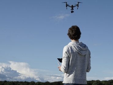 man navigating flying drone