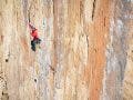 adventure photography of climber on rock face