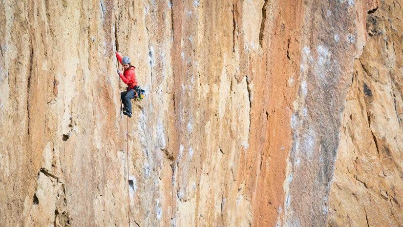 adventure photography of climber on rock face