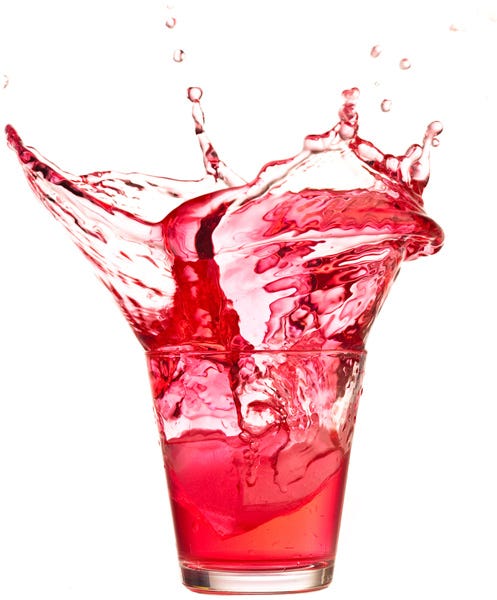 Splash of red liquid in glass