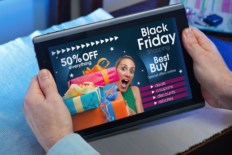 man checking out black friday deal on tablet monitor