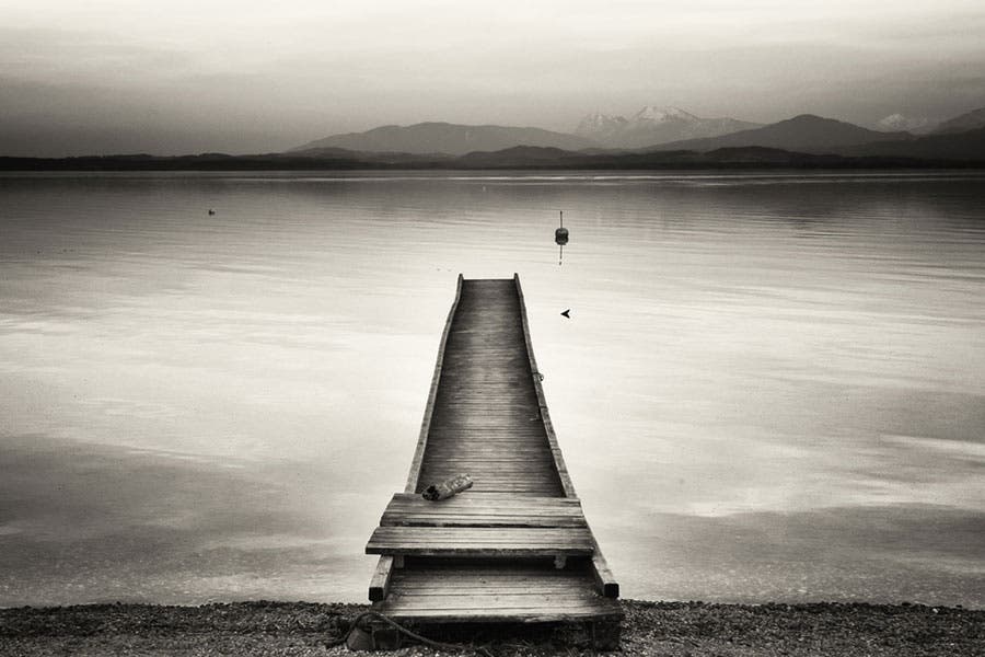 Monochrome sepia photo of dock on a lake