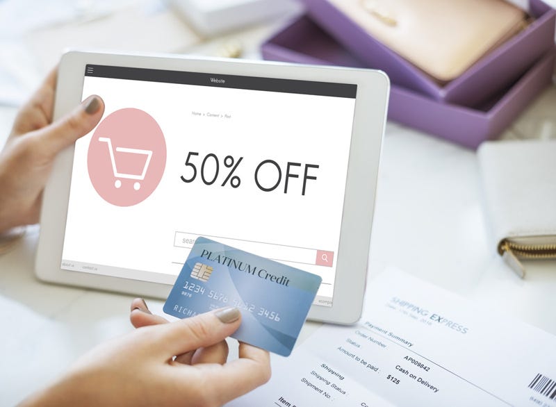 lady holding credit card and tablet showing 50% off black friday deal