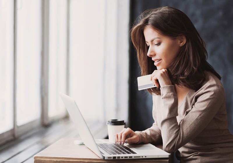 woman using rewards card to avail on top of cyber monday offerings