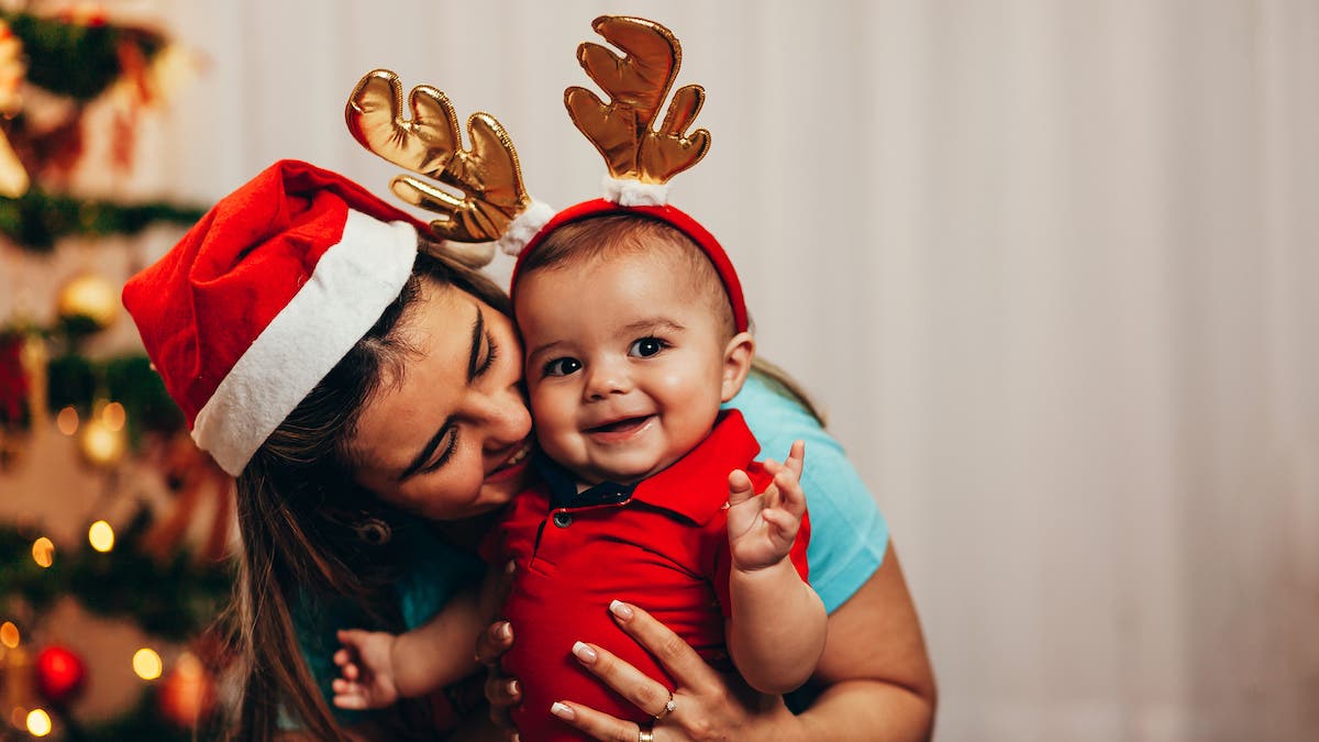 Mother and her baby playing at home on Christmas holiday