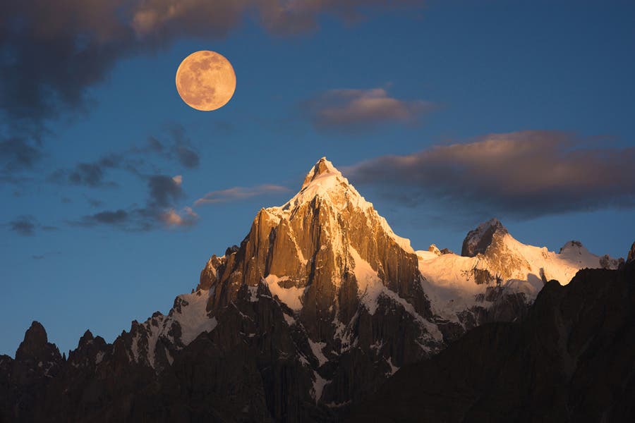Shot of the moon on top of the alps
