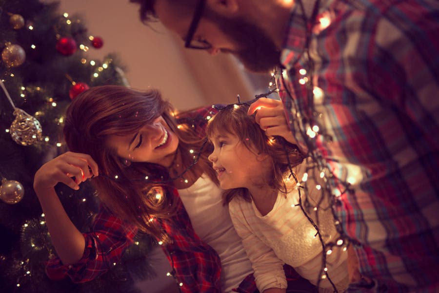 family Christmas photo with Christmas lights