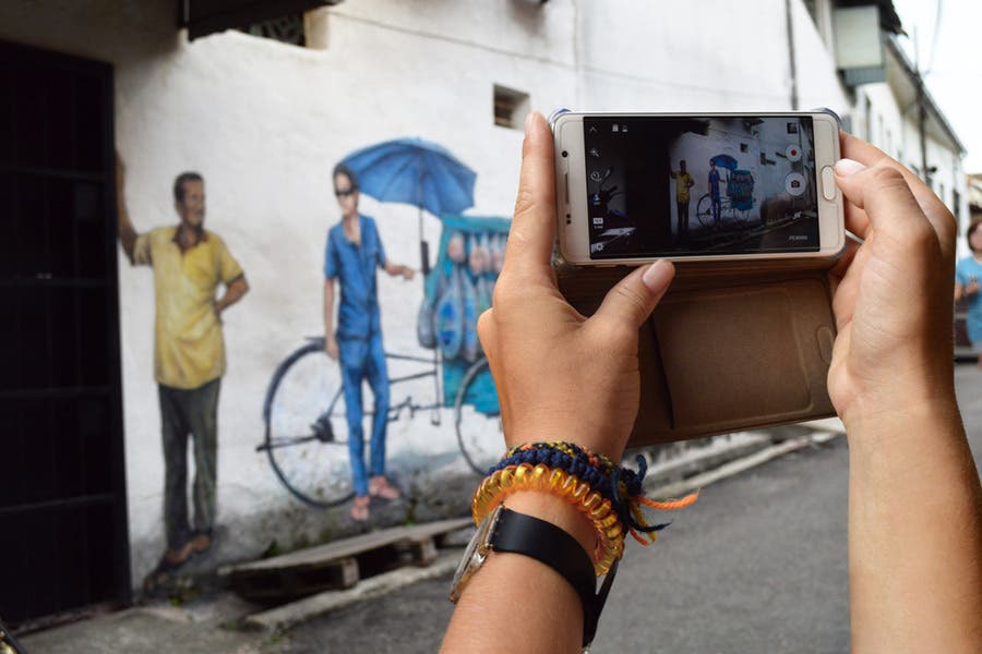 person holding a smartphone camera for street photography
