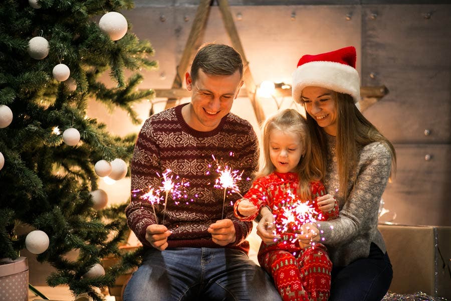 family Christmas photo holding sparklers