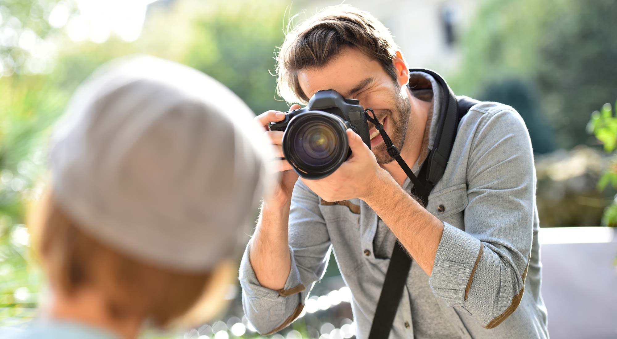 Photographer taking picture of trendy model in park