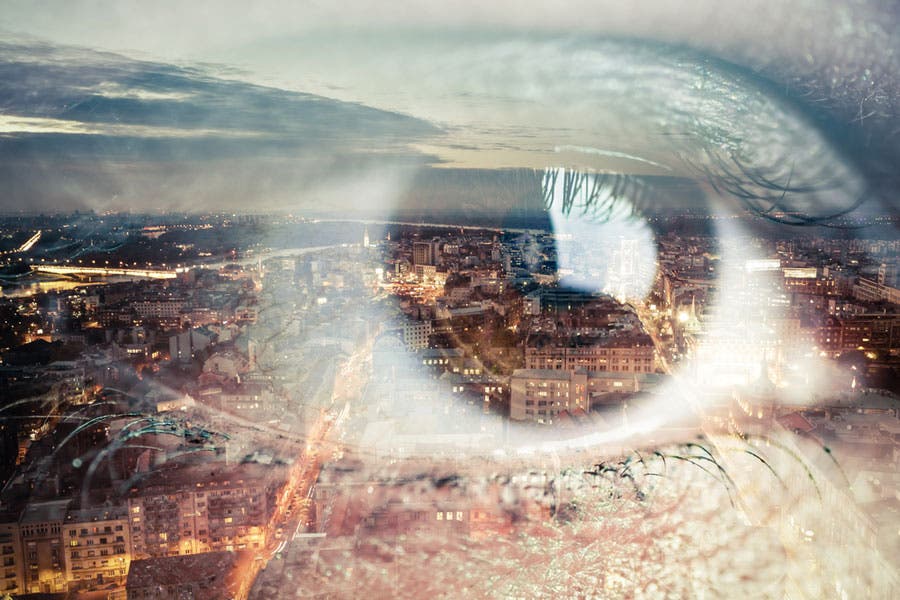 Double exposure of eye and cityscape