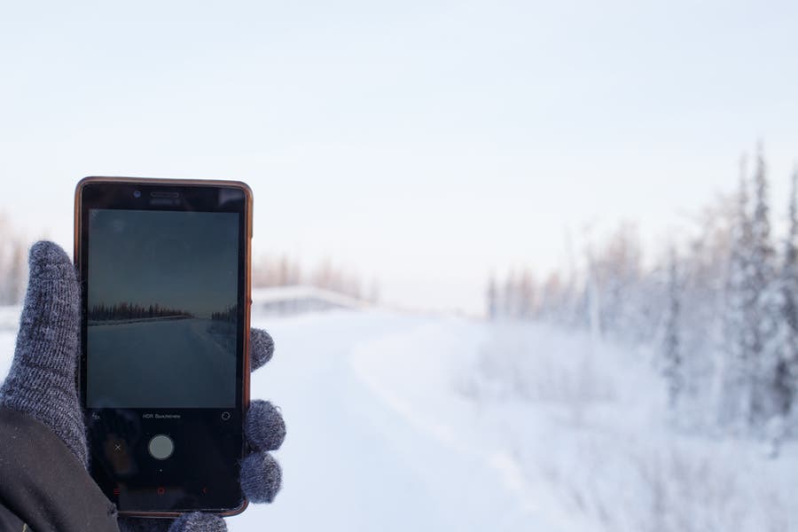 person taking a photo outdoors in the snow