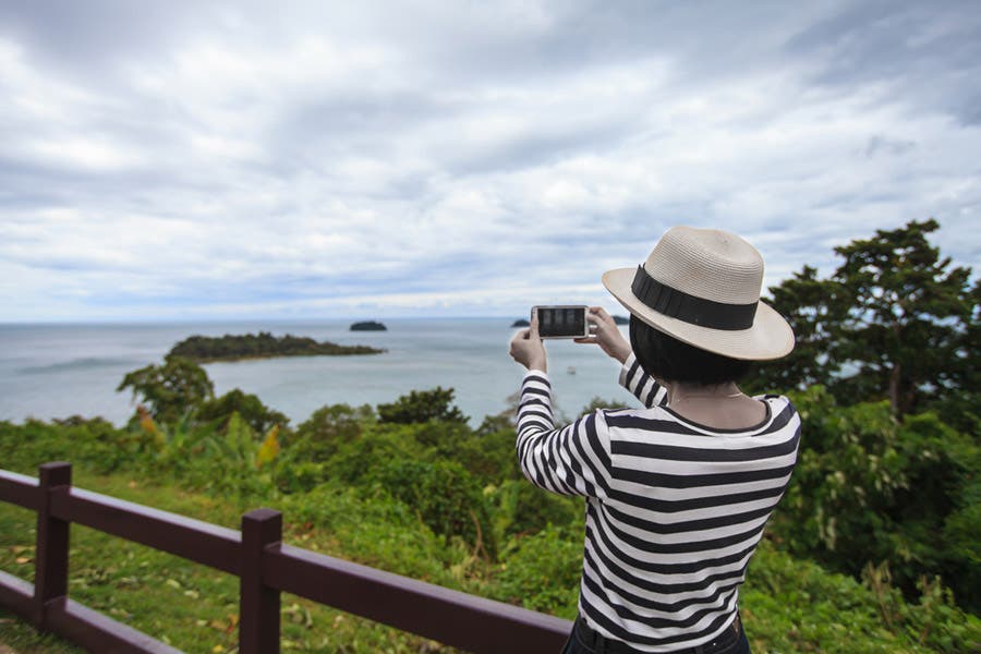 woman taking a photo outdoors
