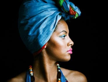 Studio side portrait of african woman in a colorful ensemble