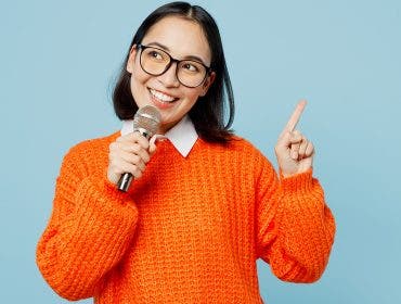 image of woman holding a microphone via adobe stock
