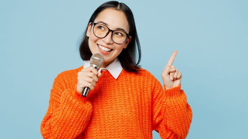 image of woman holding a microphone via adobe stock