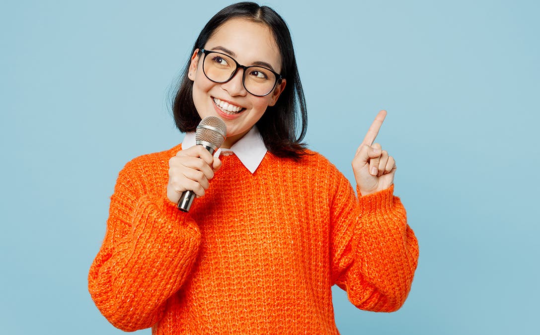 image of woman holding a microphone via adobe stock