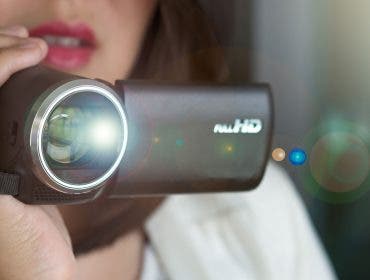 A woman shooting video on a camcorder