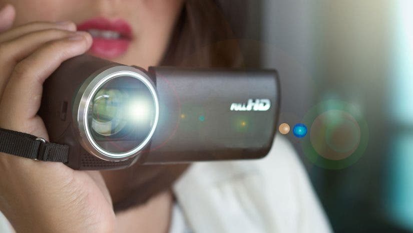 A woman shooting video on a camcorder