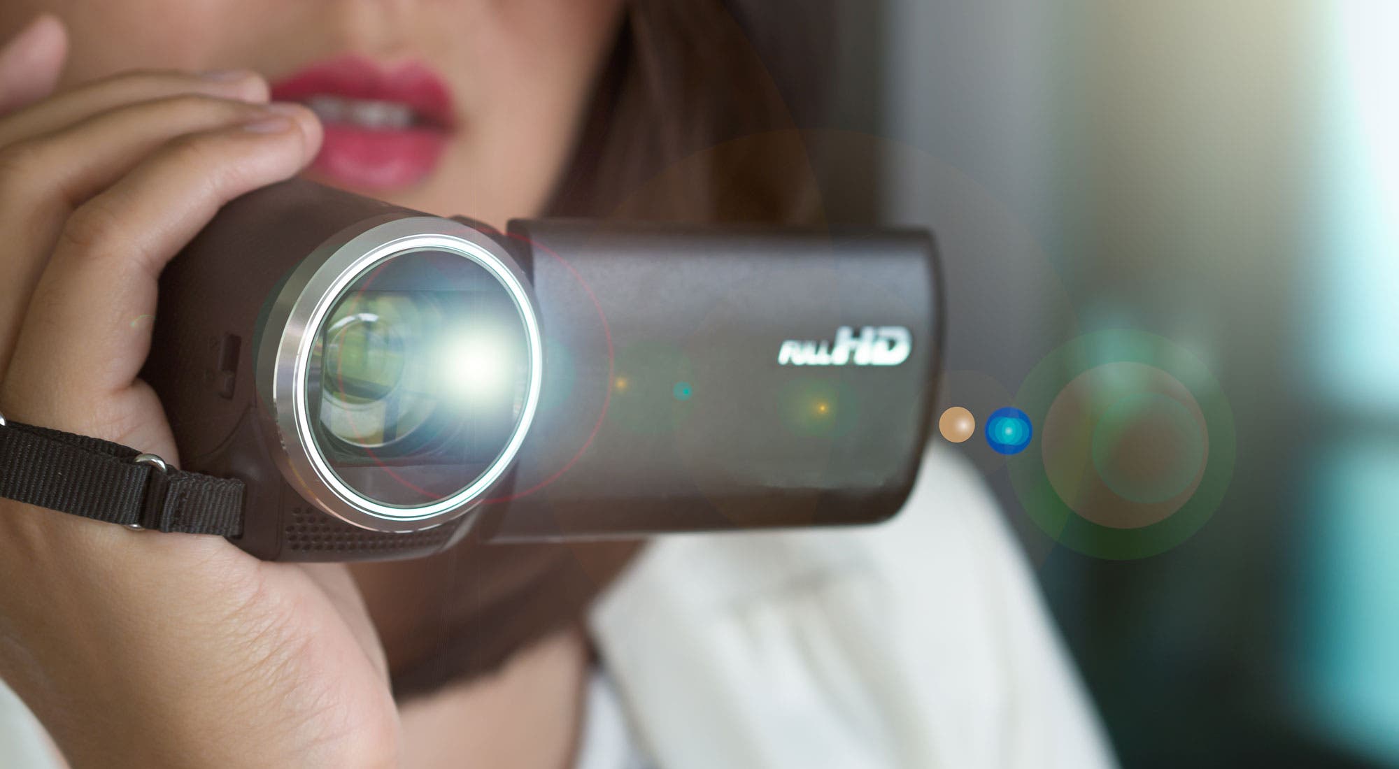 A woman shooting video on a camcorder