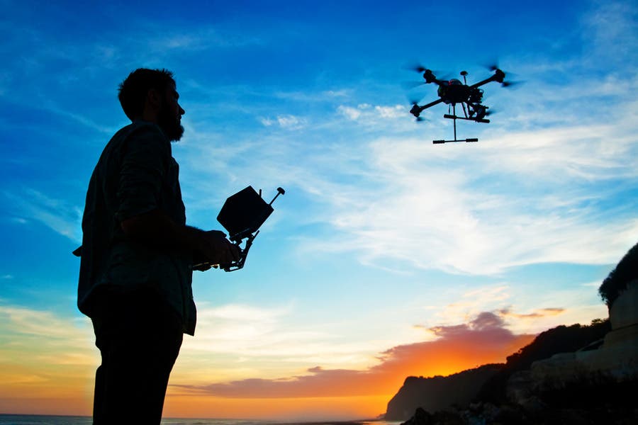 silhouette of drone and operator