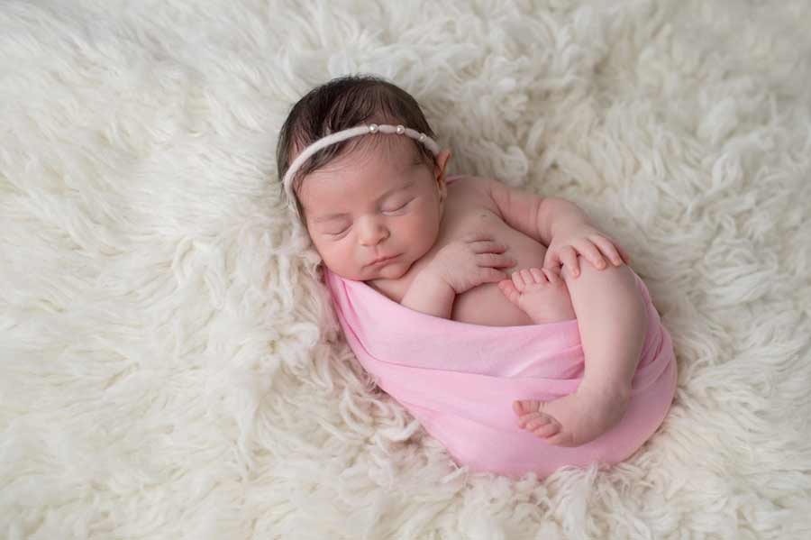 newborn photography shot of an adorable sleeping baby girl