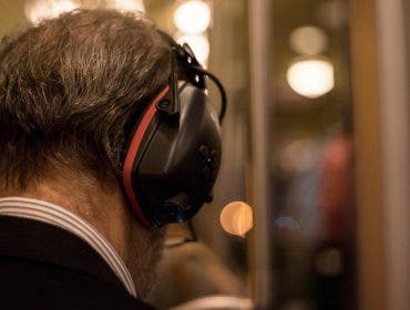 Man with noise-canceling headphones on train