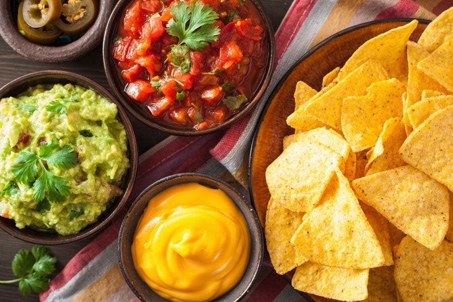 overhead shot of nachos with dips