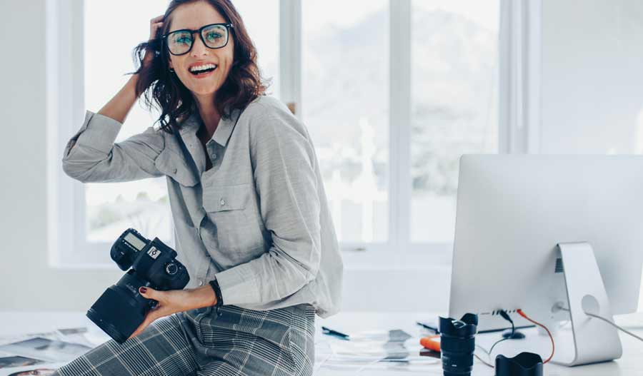 smiling photographer in her work room
