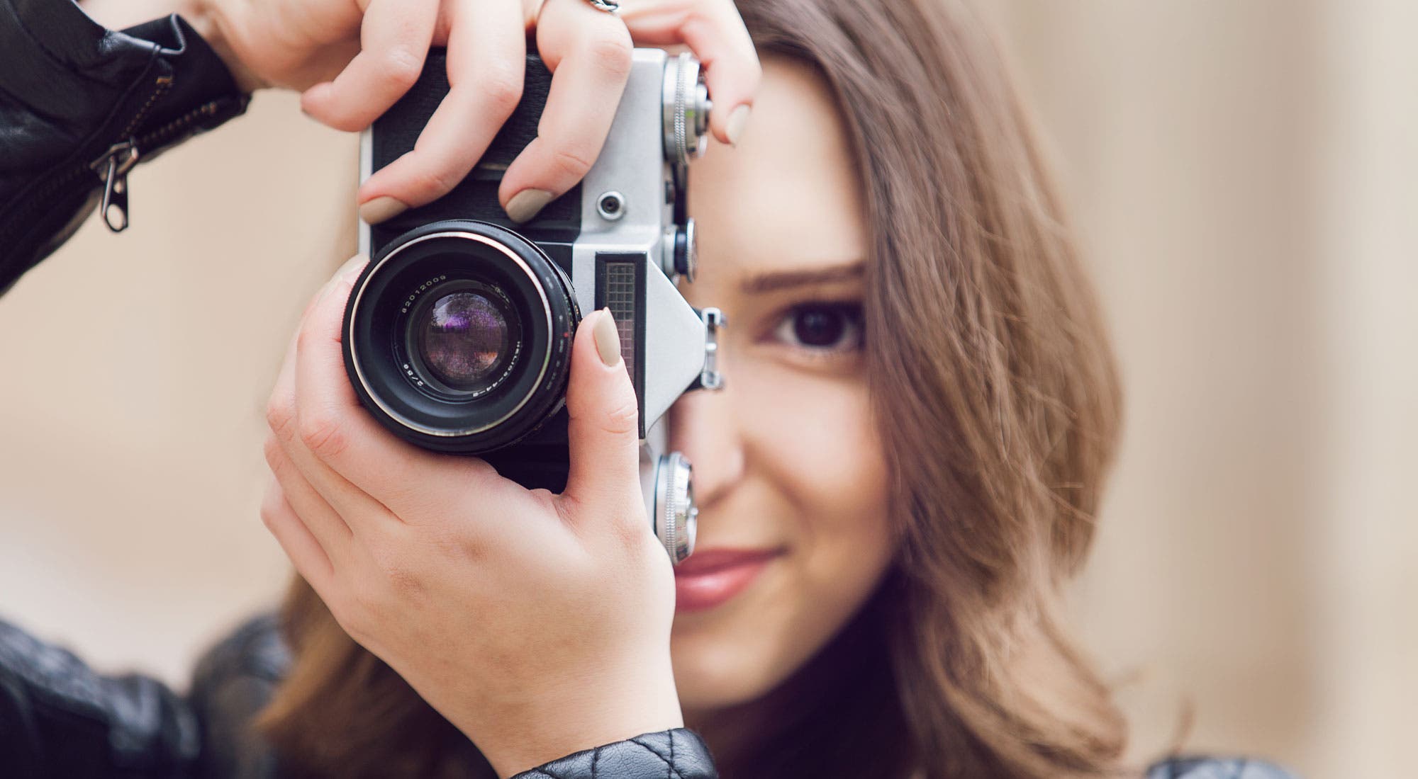 woman taking a photo with an old 35mm camera