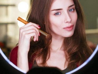 beauty guru doing makeup video in front of ring lights