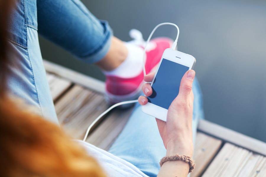 lady listening to podcast on iphone