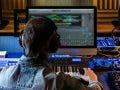 Music producer editing and mastering audio tracks