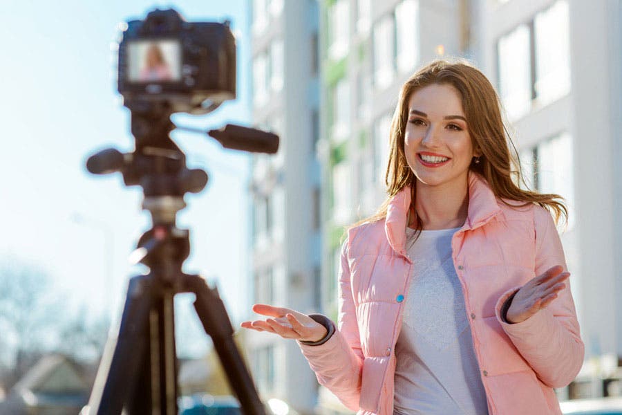 woman speaking in front of a vlogging camera