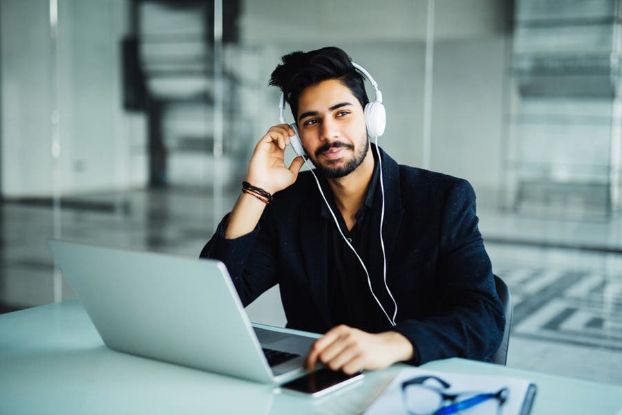 male podcaster reviewing his show online