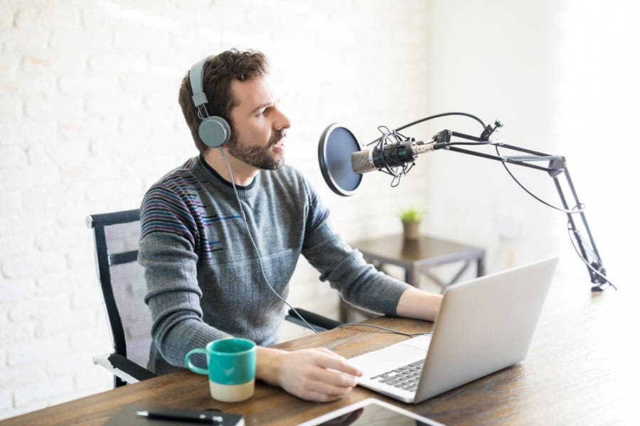 male podcaster recording