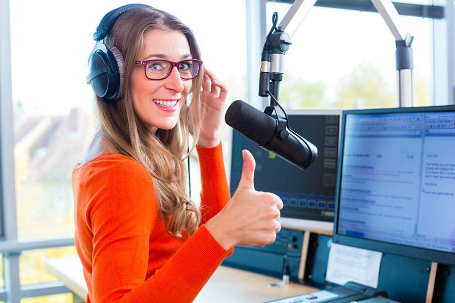 female podcaster doing a thumbs up