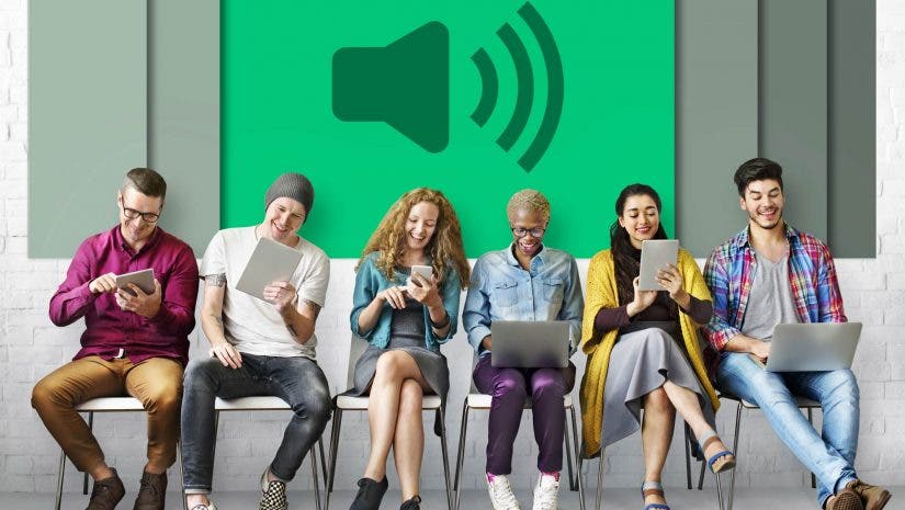 conceptual image of group of people with screen gadgets and audio icon in background