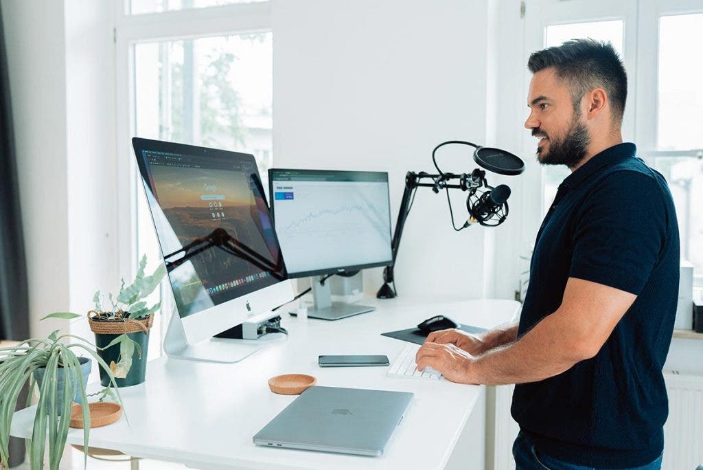 man recording podcast at desk