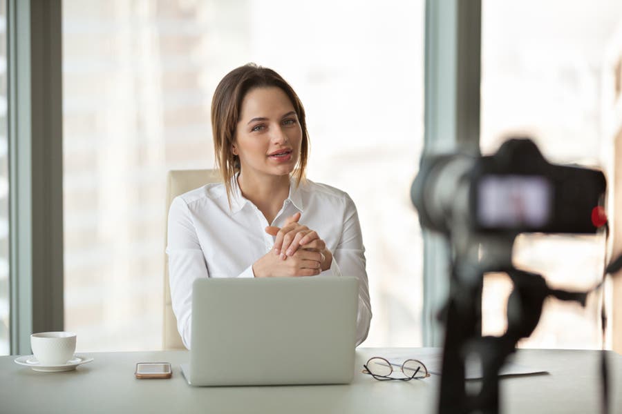 woman recording herself in minimalist office space