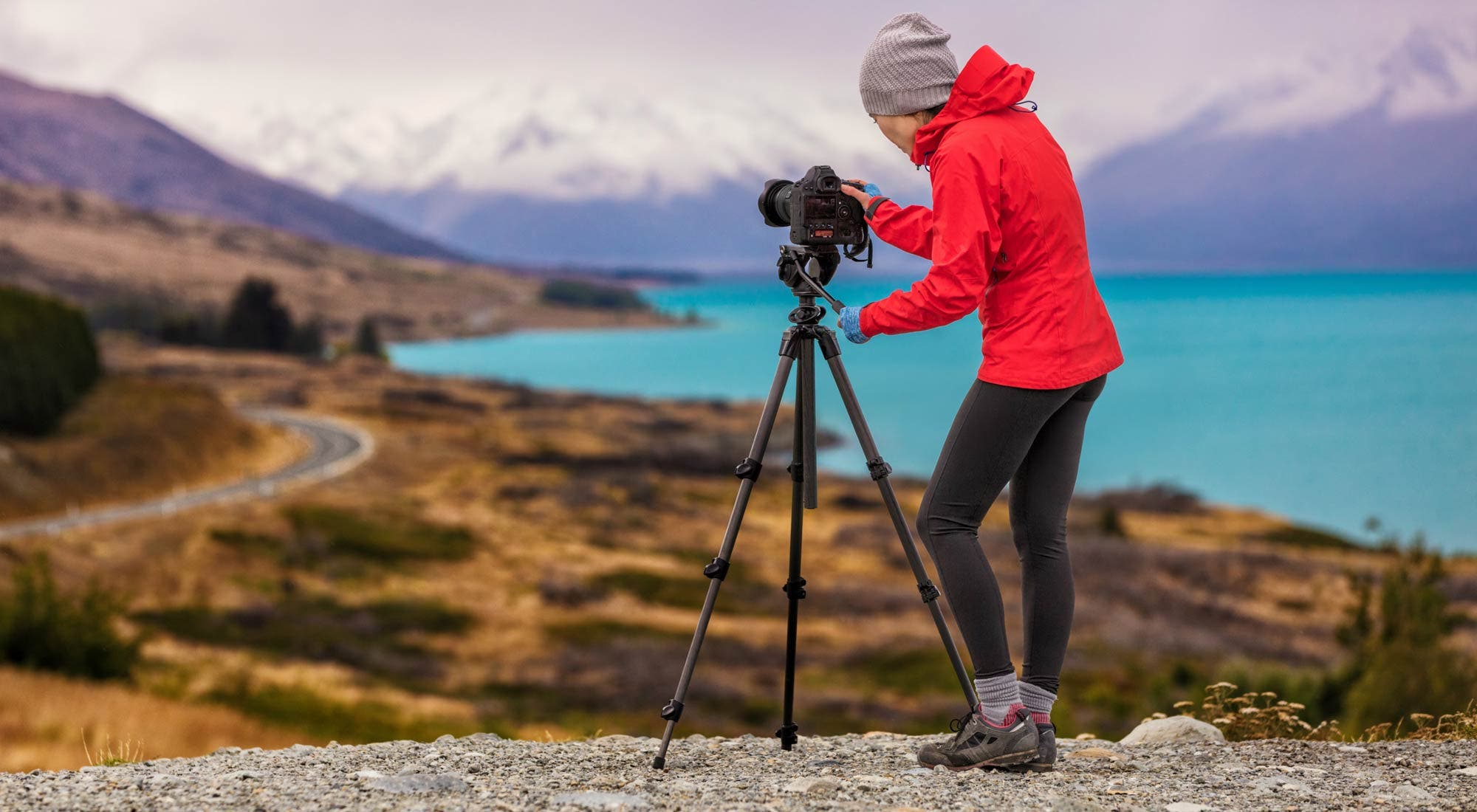 photographer setting up camera on tripod for overlooking shot