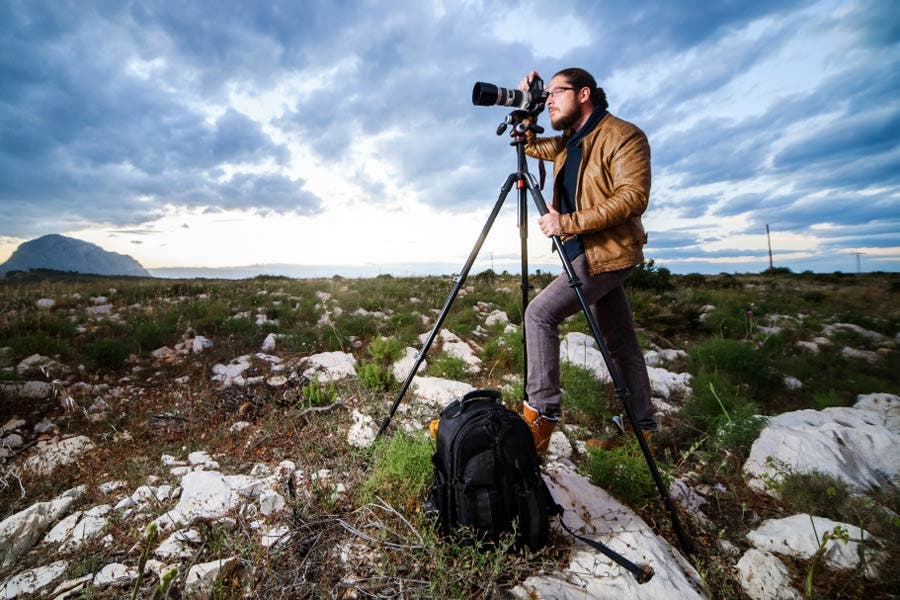 wide shot of photographer shooting with a tripod outdoors