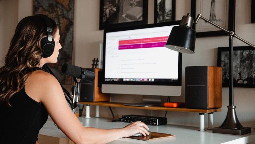 woman at computer recording podcast