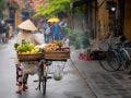 Woman walking in Hoi An with fruits