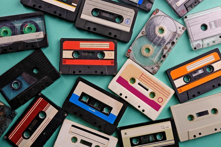 Audio Bandwidth - collection of cassette tapes scattered on blue-green table surface