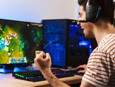 male gamer playing on gaming desktop computer