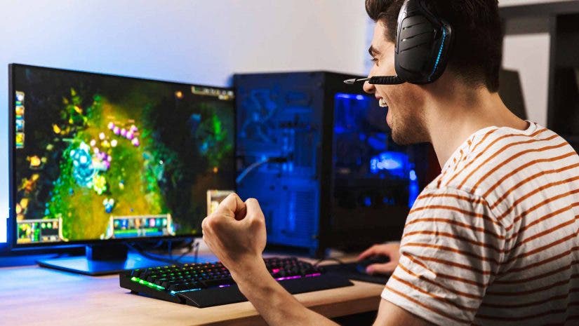 male gamer playing on gaming desktop computer