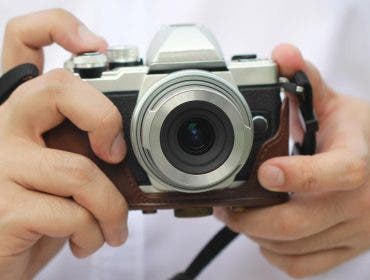 Man holding a mirrorless camera